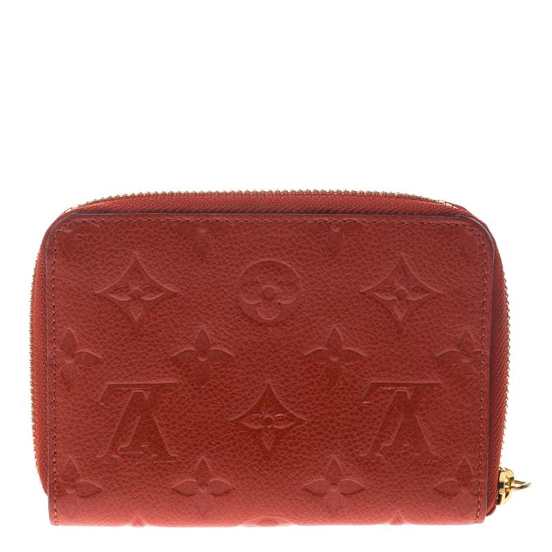 Bringing a blend of remarkable fashion and fine craftsmanship is this compact wallet from Louis Vuitton. The wallet comes crafted from Monogram Empreinte leather and designed with a zipper that opens to reveal multiple card slots and a zip