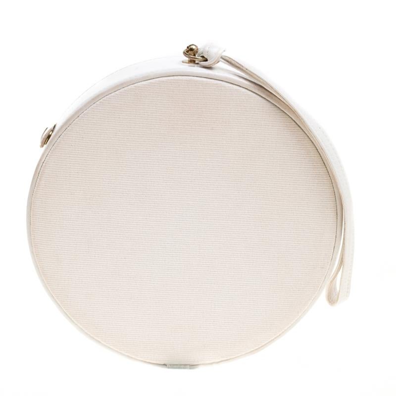 Olympia Le Tan's Caviar clutch is designed for women with a rich sense of fashion. Sculpted in a circular shape, the front of the clutch is crafted from white fabric and is styled with a fish and rope appliques along with brand detailing and bold