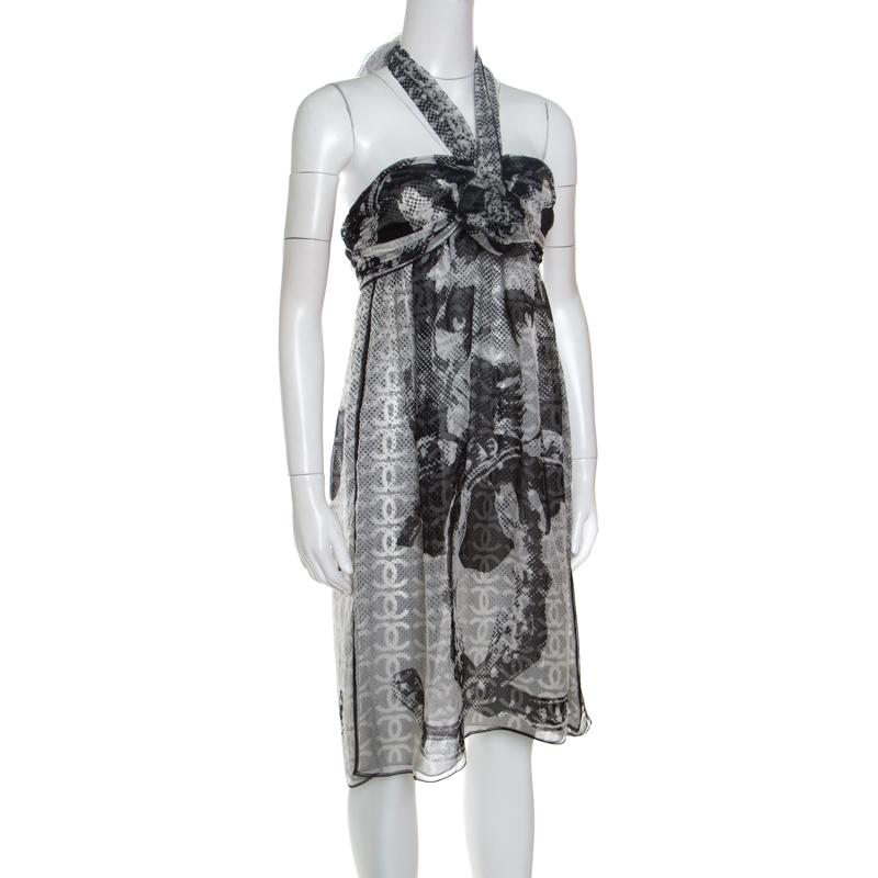 Elevate your holiday closet with this monochrome, silk dress from the house of Chanel. It is crafted in a fabulous silhouette and is lifted by self-tie halterneck straps. The simple fluid bottom of the dress falling to the knee-length steers