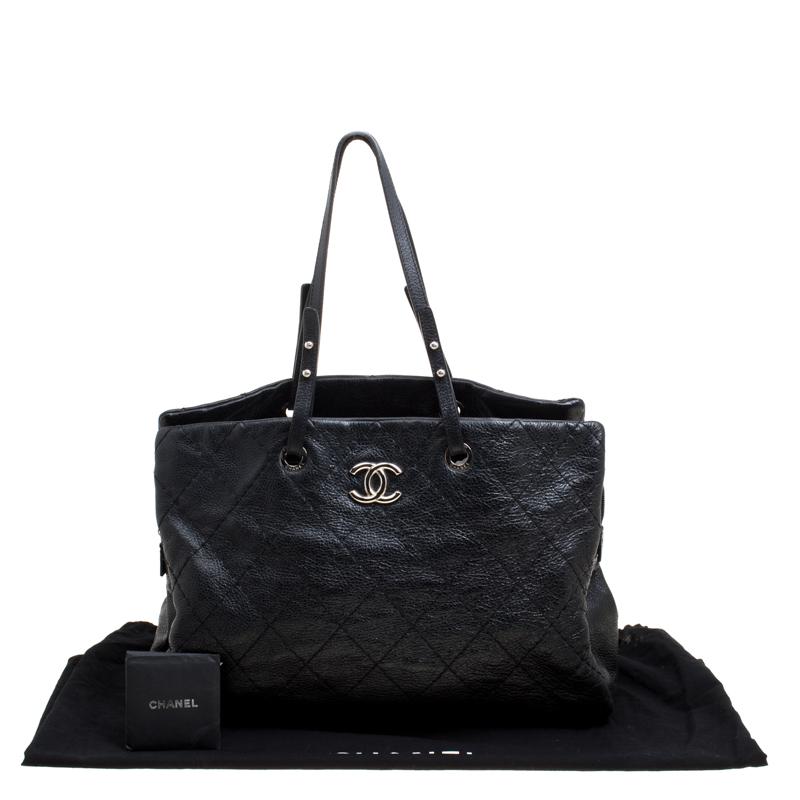 This Chanel On The Road Tote Bag is perfect for all your daily needs. Crafted from black quilted glazed leather, it features a silver-tone CC logo, an open top with a middle zip compartment and comfortable shoulder straps. Its roomy interior is