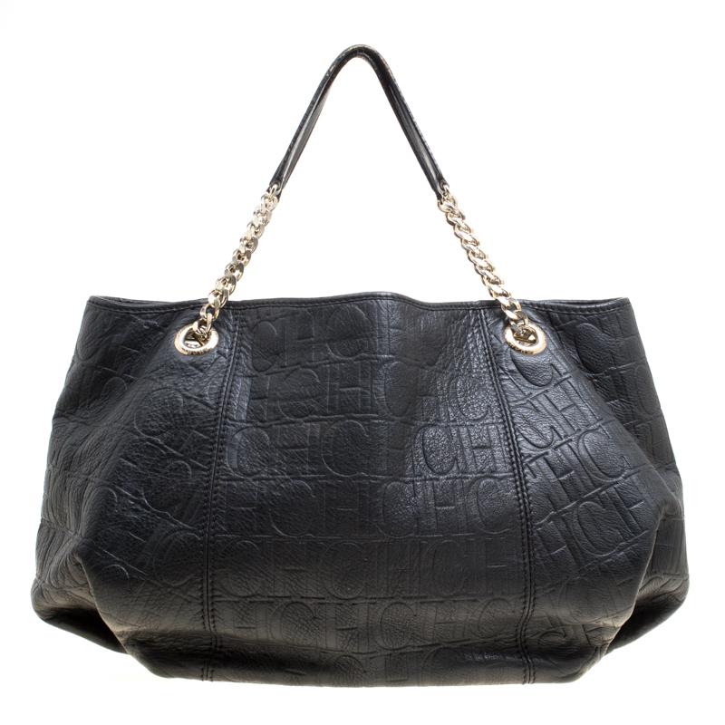 This shoulder bag from Carolina Herrera has been crafted from monogram leather and designed with a well-sized fabric interior. It is held by chain handles with leather rests for an easy carrying experience. This bag is not only high in style but