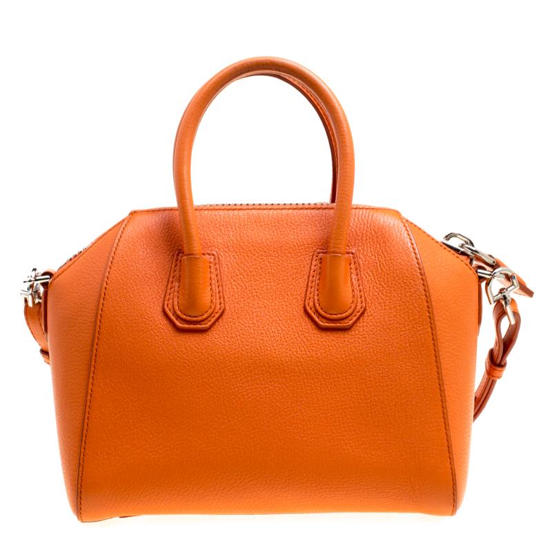 Made in Italy, and loved by women worldwide is this beautiful Antigona satchel by Givenchy. It has been crafted from leather and shaped elegantly. The orange bag has a top zipper that reveals a canvas interior and it is held by two top handles and a