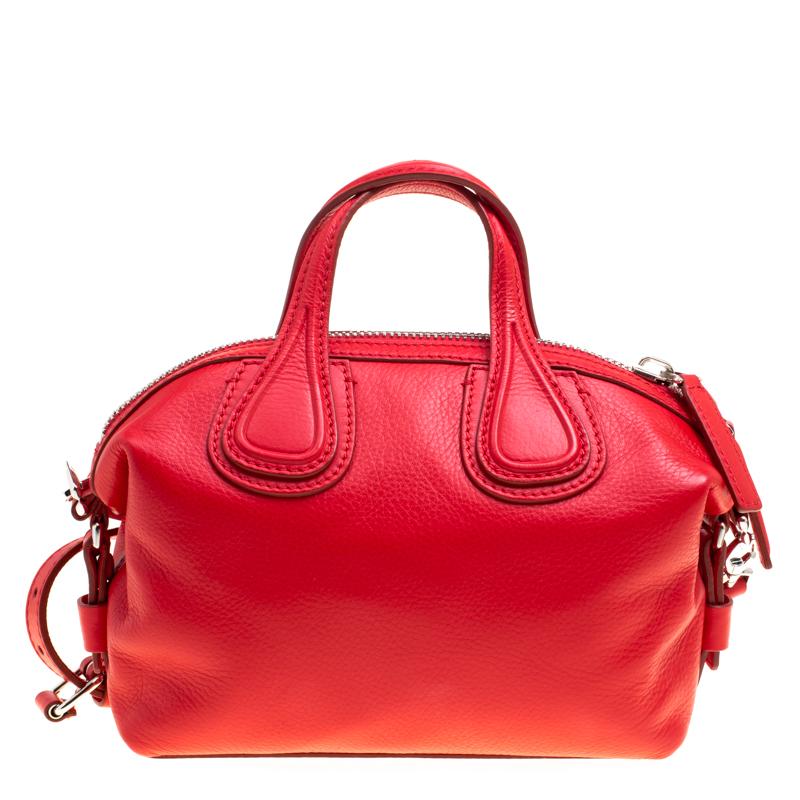 Excellently crafted from red leather for a bright touch, this Nightingale bag from Givenchy is a creation that is ideal for daily use. It features two top handles, a shoulder strap and a spacious canvas interior to dutifully hold your