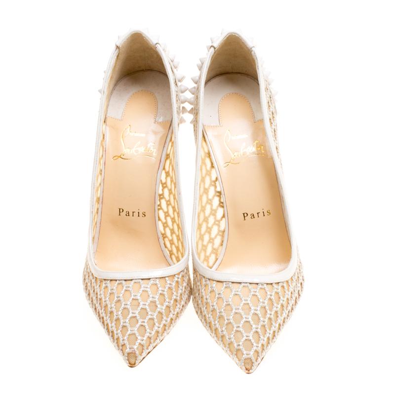 Creating an aura of elegance are these lovely Guni pumps from Christian Louboutin. These off-white pumps are crafted from mesh and patent leather trims and feature pointed toes. They flaunt spikes embellished on the heel counter and come equipped