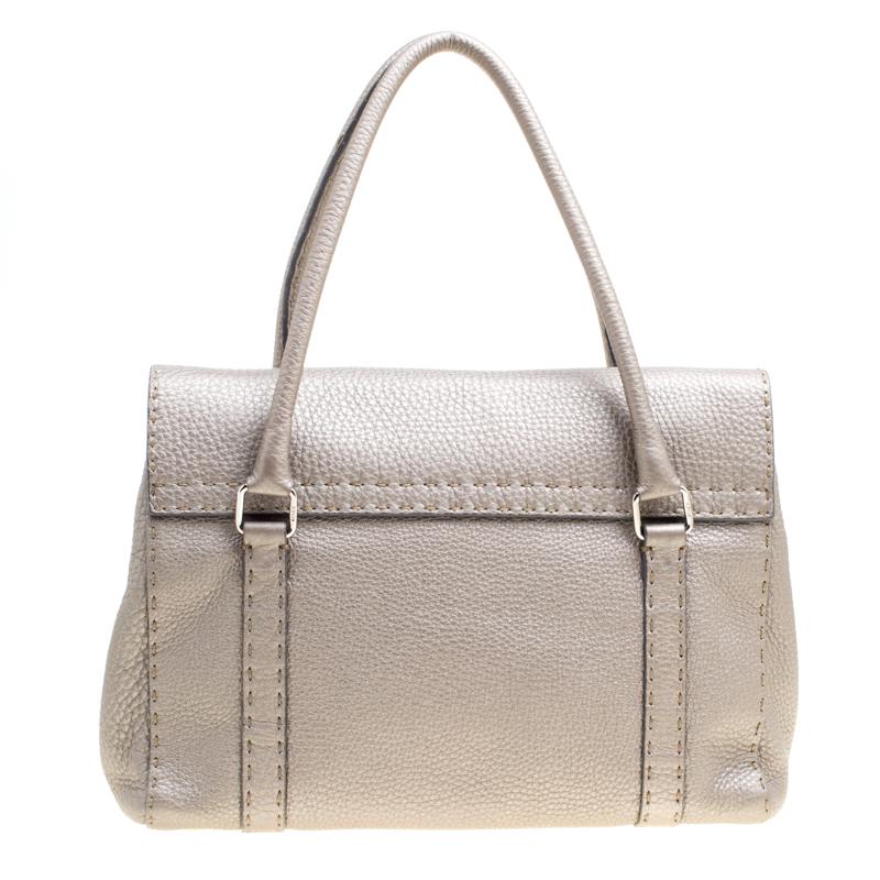 Perfect to tote at work, this 'Linda' satchel from Fendi is a must-have! Crafted from leather, the bag features dual handles, silver tone hardware, protective metal feet and a front buckled closure. The grey satchel opens to a canvas lined interior