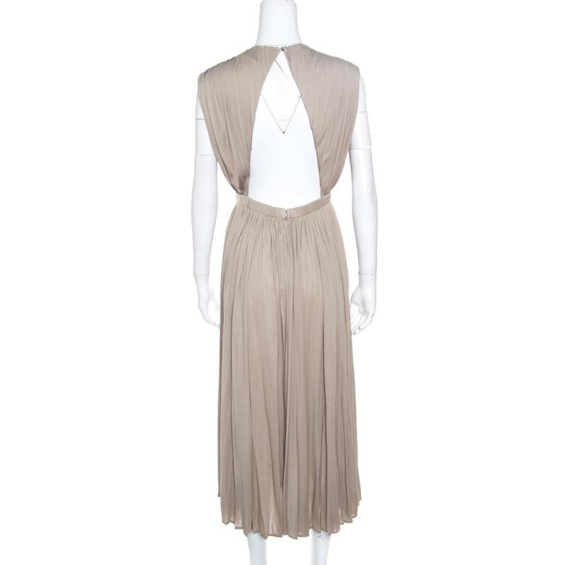 You'll never go unnoticed when you step out wearing this amazing dress from Valentino. The beige creation is made of 100% silk and features a pleated silhouette. It flaunts a round neckline, a cinched waist and a cutout detailing at the back. Pair