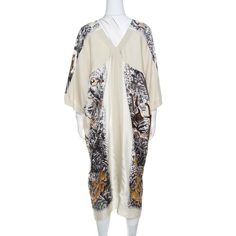 This cream tunic dress from Hermes is made of silk and cashmere and features a lovely Jungle Love printed pattern all over it. It flaunts a round neckline, short sleeves and a deep back. Pair it with smart platform sandals and a leather clutch to