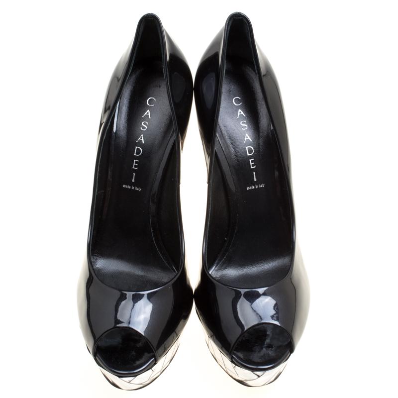 This pair of peep-toe pumps by Casadei will leave you looking like a diva. They are covered in patent leather and has mosaic mirror detailing on the 15.5 cm heels and platforms. Add some style to your closet by slipping into this pair of black