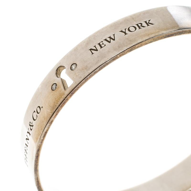 Tiffany Locks is collection from Tiffany & Co. which is inspired by archival designs. This lovely bracelet designed in a minimalist bangle style with sterling silver is engraved with the brand label and 'New York'. It also features a cutout lock