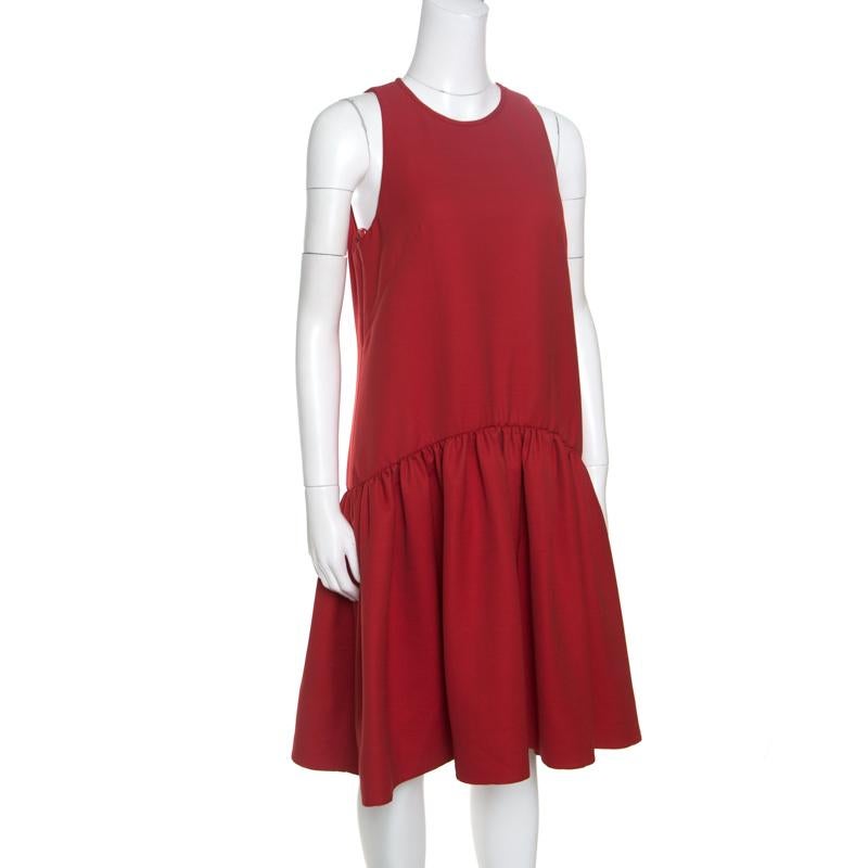 This Babydoll dress from Alexander McQueen is an outfit you will instantly fall in love with. It has a minimalist yet pretty silhouette designed with feminine aesthetics. It is cut from a wool blend and carries a lovely red hue. While the bodice