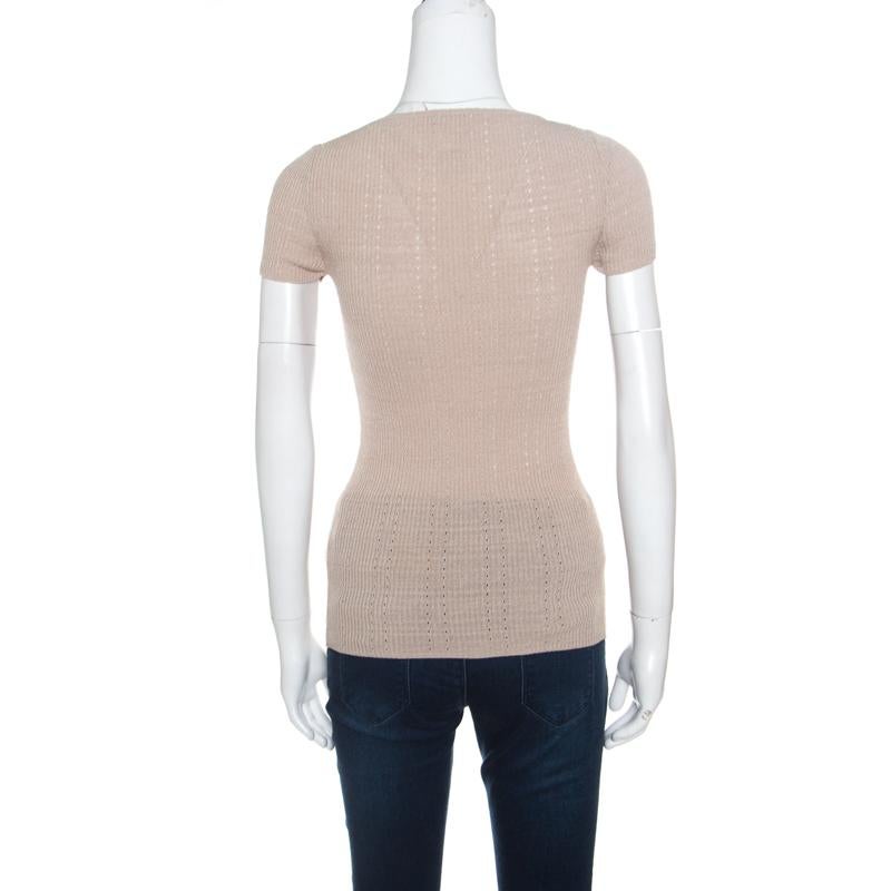 It's impressive how such a simple style looks so exquisite, this Chanel top has been beautifully crafted in a blend of cotton and nylon with perforated patterns. The beige top is accentuated with ribbed knitting and features the signature CC