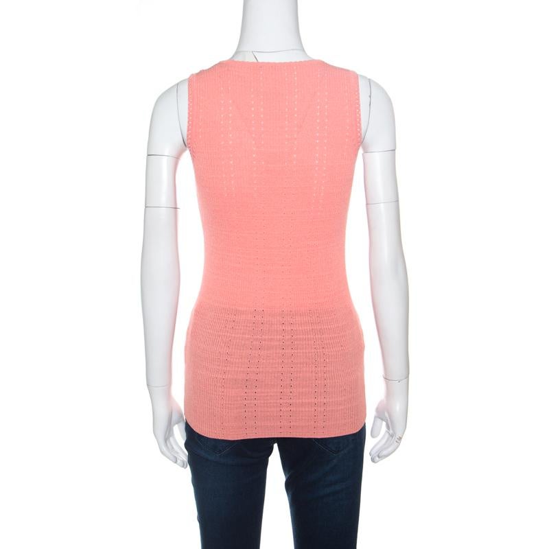 It's impressive how such a simple style looks so exquisite; this Chanel tank top has been beautifully crafted in a blend of cotton and nylon with perforated patterns. The peach top is accentuated with ribbed knitting and features the signature CC