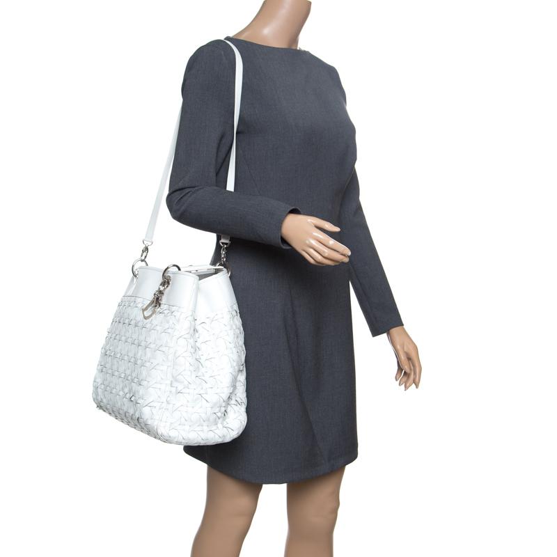 This sophisticated and feminine Lady Dior tote in your hand is apt for the perfect Dior look. Crafted from leather, this pristine white Avenue tote is accented with a woven pattern and silver-tone hardware. It features signature Dior charms, two