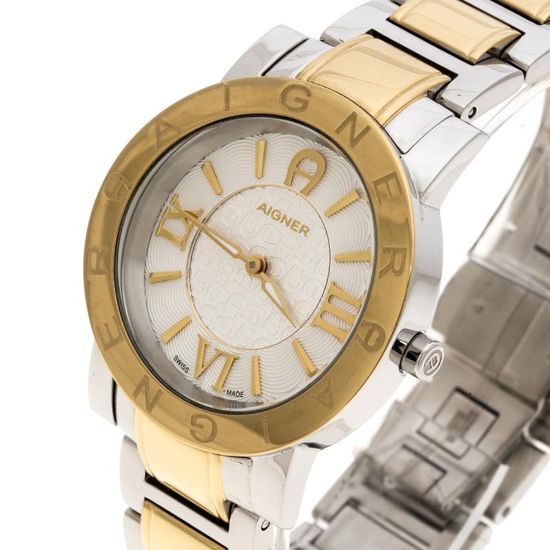 Designed in a gold-plated stainless steel body, this Aigner Cortina watch comes with a case diameter of 36mm. It features a rounded dial detailed with Roman numerals, a brand etched bezel and gold-tone hands. Powered by quartz movement, this watch