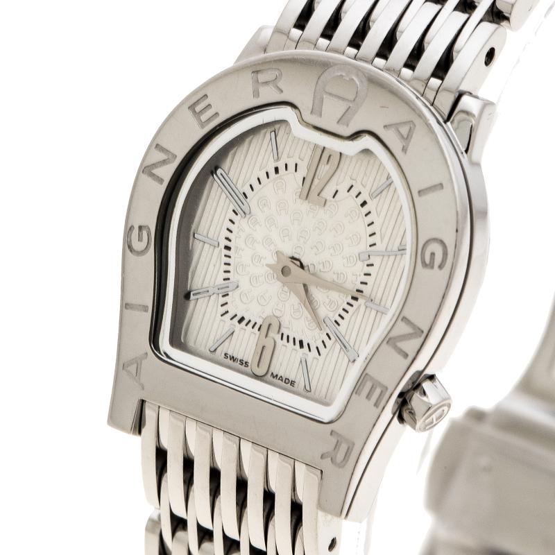 This watch from the house of Aigner is cast in a stainless steel body with a case diameter of 24mm. It features the logo shaped dial from the house with the brand name engraved on the bezel. It features a white dial detailed with silver-tone markers