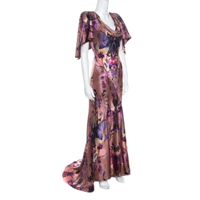 This gown from Alexander McQueen is absolutely ravishing, elegant and ultra stylish. It is made of 100% silk and looks ethereal with its flowy silhouette. It features a beautiful floral and butterfly printed pattern all over it and flaunts a cape