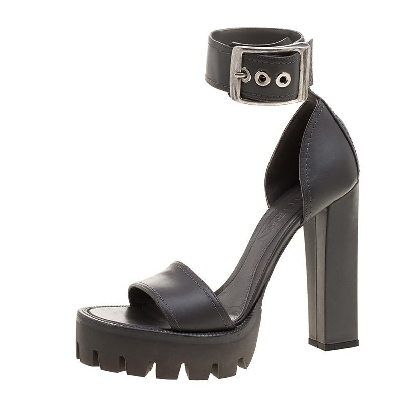 Flatter everyone with your style in these Alexander McQueen sandals. Every bit of this pair is in vogue, from the platforms to the high heels. It has a sturdy leather exterior, a broad ankle strap with an oversized buckle, leather lined insoles, and