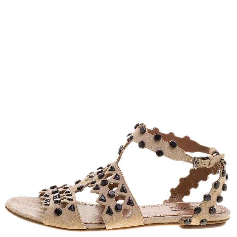 You'll truly be in utter love with these sandals from Alaia as they are stylish and modern. They flaunt simple suede straps with cutouts and stud embellishments, ankle fastenings, and comfortable insoles. The sandals are just perfect to nail a chic
