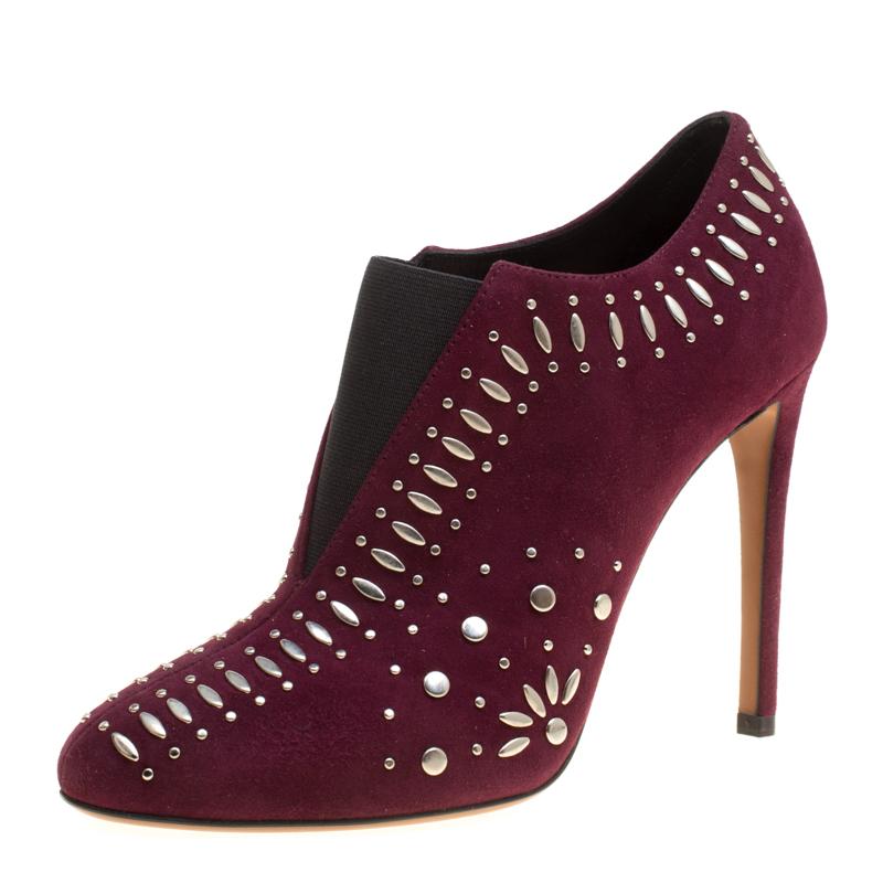 Breathtakingly beautiful are these booties from Alaia! The burgundy booties are crafted from suede and elastic bands and features round toes, multiple silver-tone studs adorned all over the exterior, comfortable leather lined insoles and 11 cm