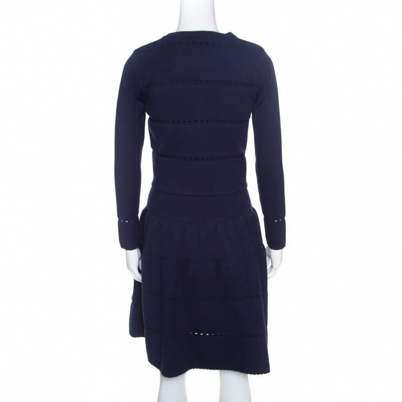 This dress set from Alaia is gorgeous! It is made from a wool blend and it comes with a cardigan that matches the dress. The dress has a V neckline and a flared skirt while the cardigan has front buttons and long sleeves. You can wear it with glossy