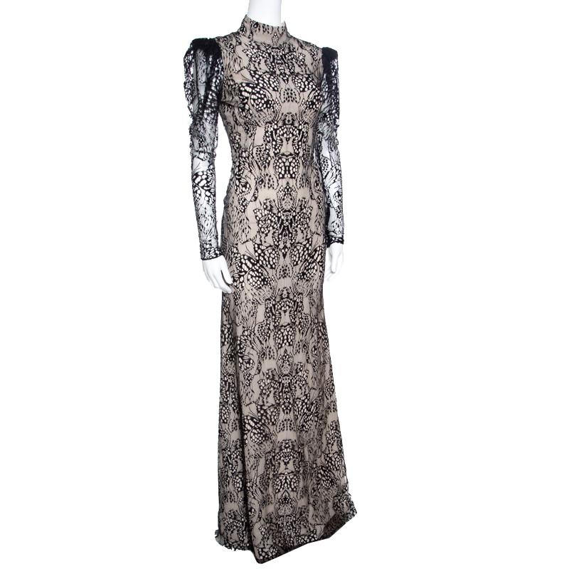 You're ready to slay the audience and channel your inner goddess with this spectacular gown from Alexander McQueen! Breathtaking in beige and black, this creation is a cotton blend and is adorned with a butterfly lace texture all over. It flaunts a