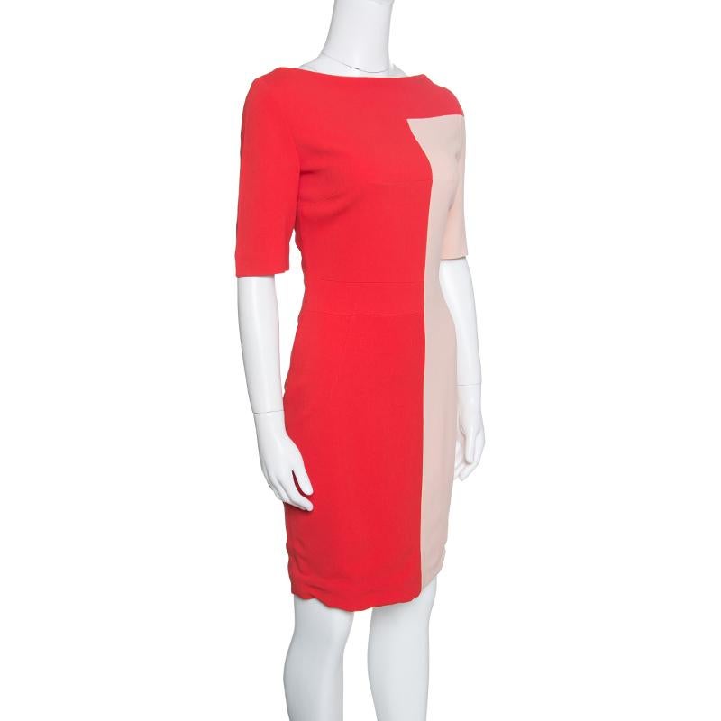 All eyes will be on you when you step out in this gorgeous dress from Antonio Berardi. The red and peach colourblock dress is made of a blend of fabrics and features a flattering silhouette. It flaunts a high boat neckline, short sleeves and a long