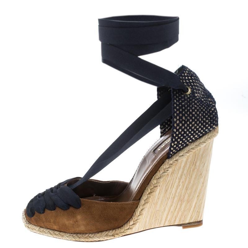 These Malibu sandals from Aquazzura are chic, smart and very stylish. The brown and navy blue sandals are crafted from suede and feature round toes with grosgrain ribbon detailing that extends to the heel counter and forms ankle wraps. They come