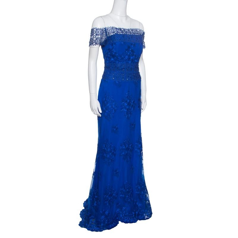 Stunning in cobalt blue, this gown from Badgley Mischka spells magic and will fetch you admiring glances wherever you go! The gown features an exquisite floral embroidered tulle overlay and off-shoulder sleeves. It flaunts a flattering silhouette