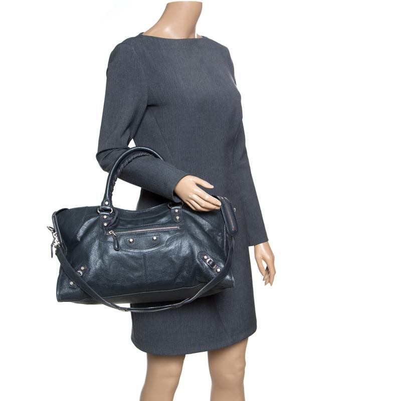 This bag from Balenciaga makes it easy to carry your daily essentials. Crafted from leather, this anthracite bag is provided with silver-tone hardware. It features two hand-stitched top handles, removable shoulder straps, a front zipped pocket and a