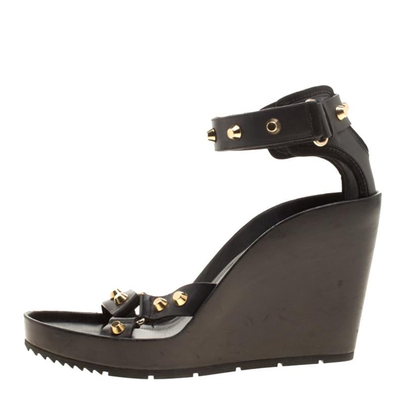 This pair of wedge sandals by Balenciaga is lovely. They've been wonderfully styled with leather straps, stud detailing and elevated on 12 cm wedges. Complete with comfortable leather insoles, this pair is a must-have.



Includes: Original Box,