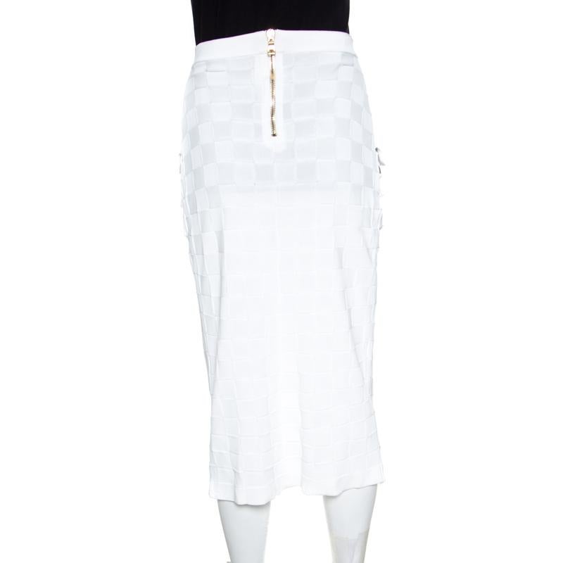 Balmain is all about powerful dressing and this white knit skirt is just another example. It is made of 100% viscose and features a flattering wrap silhouette. It flaunts a checkered design, twin patch pockets and a zip closure at the back. Sure to