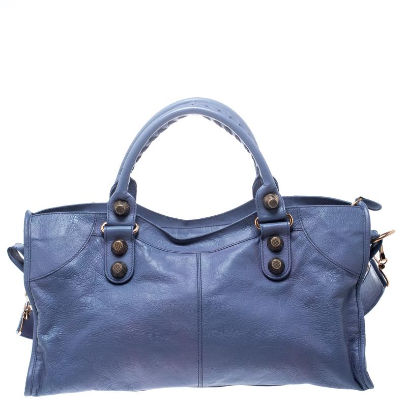 An elegant addition for your totes collection, this City bag from Balenciaga has an attractive exterior and structured body that exude a bold style making it a closet essential. Crafted from light blue leather, the bag features dual top handles and