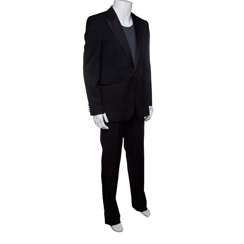 You're ready to rock any formal event and make a mark with this smart suit from Hugo Boss.. The black suit is made of 100% wool. The blazer flaunts notched lapels with satin trim detailing, button fastenings, and front pockets. The trousers flaunt a