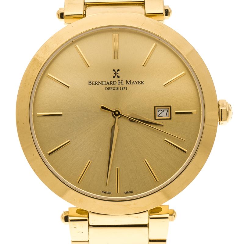 With a gold look that instantly stands out and makes a statement, this Bernhard H. Mayer Aurora watch is crafted in gold plated stainless steel all over. The gold tone round dial features a sunburst texture along with gold indexes for hour markers
