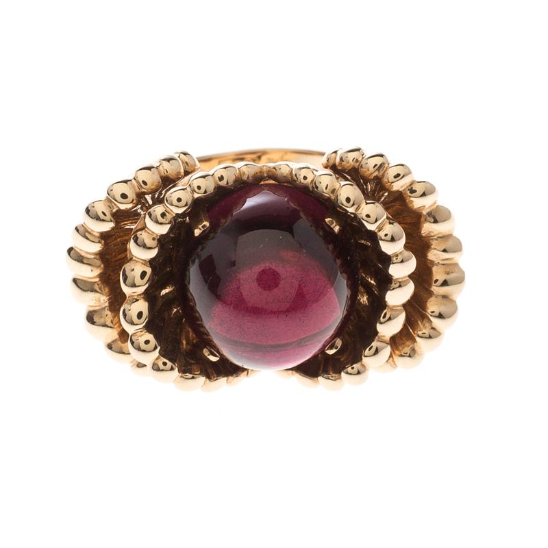 It is definitely Love At First Sight with this Boucheron ring from their Frou Frou collection. Beautifully crafted from 18k yellow gold, the ring looks like a blooming flower. It has a Garnet Cabochon at the centre with pleated cups on the sides, a