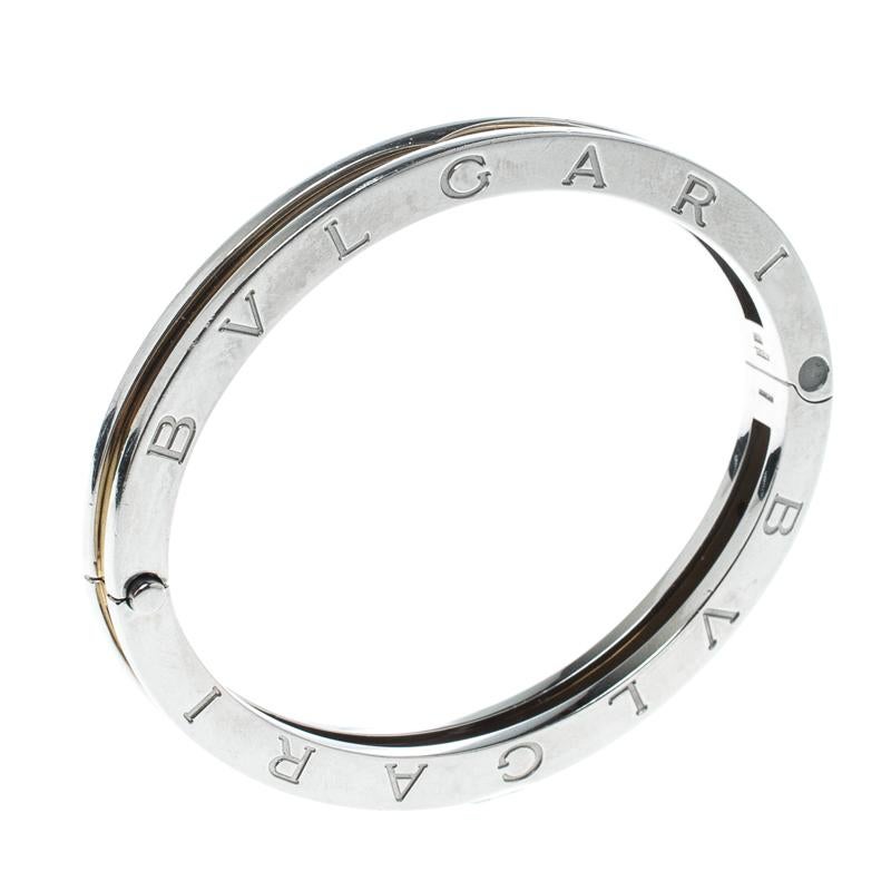 Adorn your wrist with this stunner of a bracelet from Bvlgari. The piece is from their B.Zero1 collection and it has been crafted from stainless steel and beautifully lined with 18k yellow gold. It is complete with the brand's lettering on the