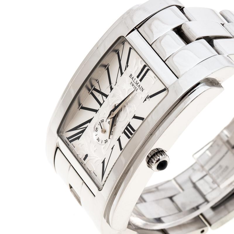 Balmain's wristwatch constructed in silver stainless steel is both chic and sophisticated, ideal to complement a variety of your looks. It features a case diameter of 32mm and comes with a white, textured rectangular dial that is equipped with Roman