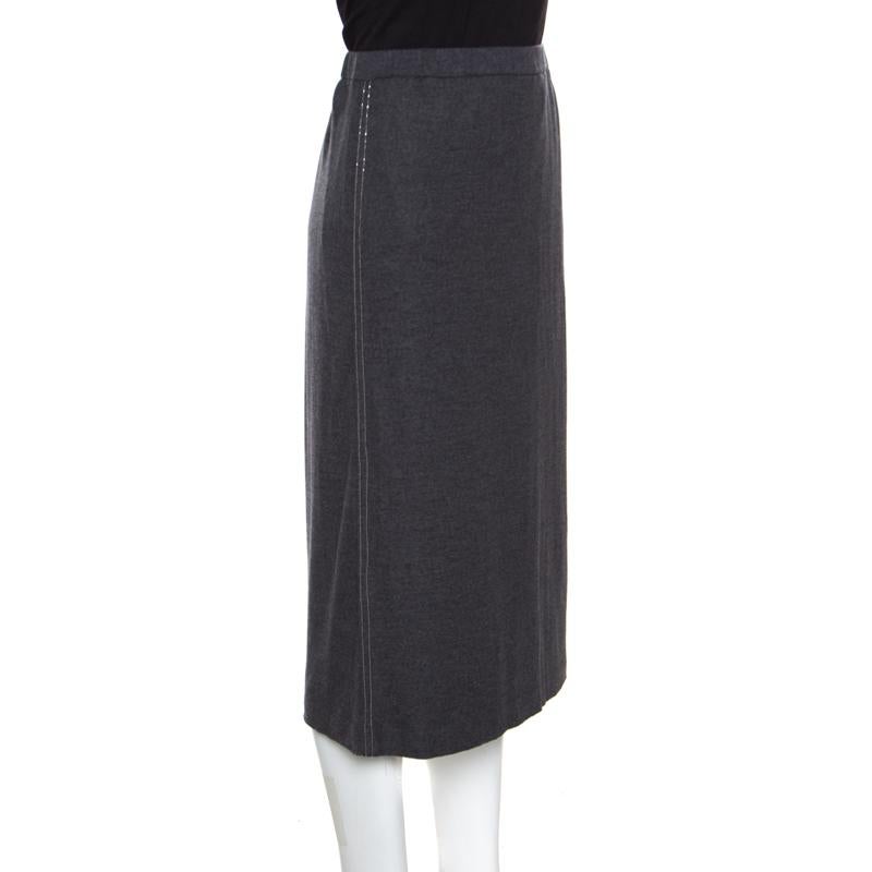 Now stay warm and stylish in this midi skirt from Brunello Cucinelli! The grey creation is made of 100% wool and features a simple structured silhouette. It flaunts an embellishment detailing on the side seams and can be paired well with chic ballet