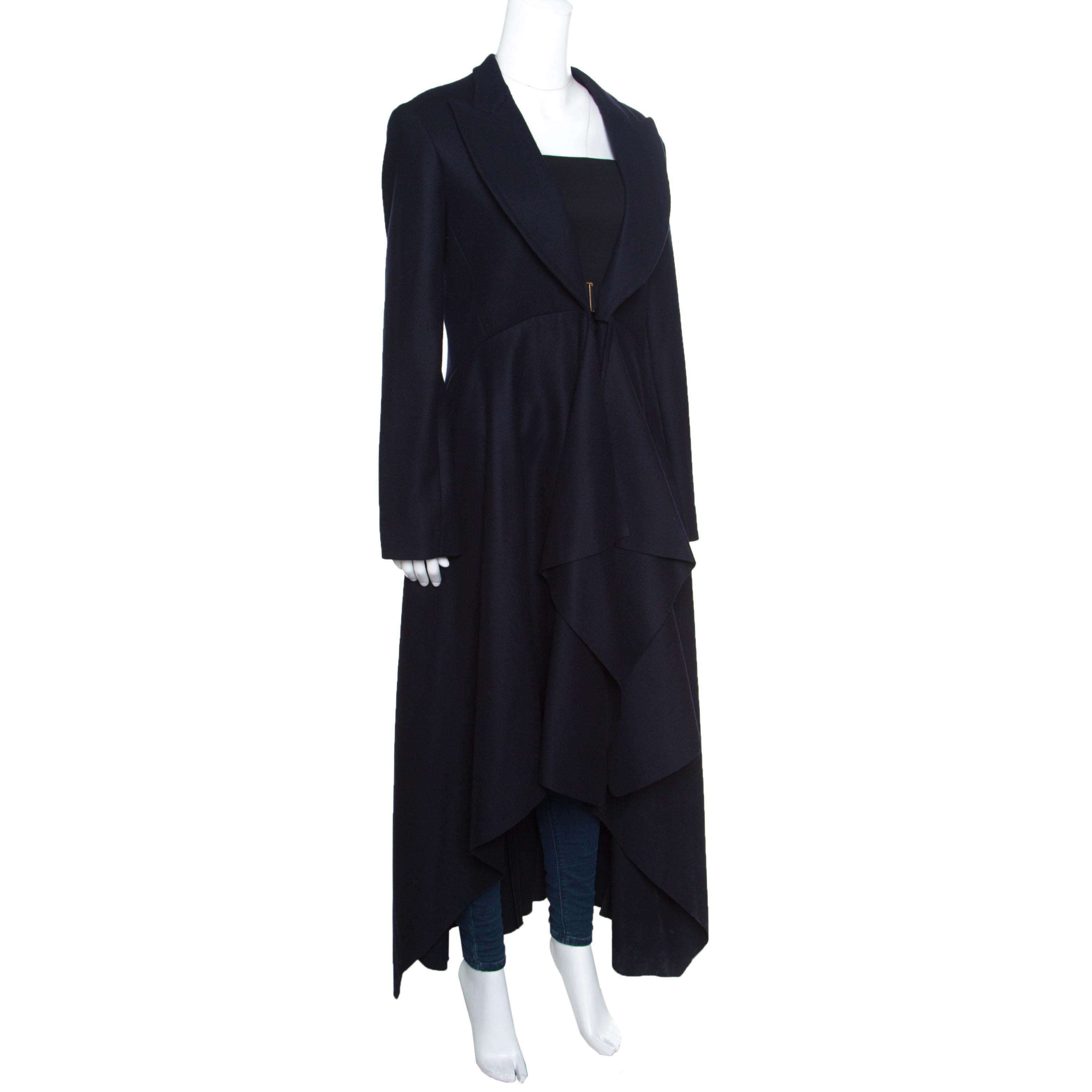 Feel and be the trendiest person in the room whenever you choose to wear this long coat from Celine! It comes tailored from the finest wool and designed to fall as drapes. Long sleeves, a buckle closure and wide lapels make this coat ready to be
