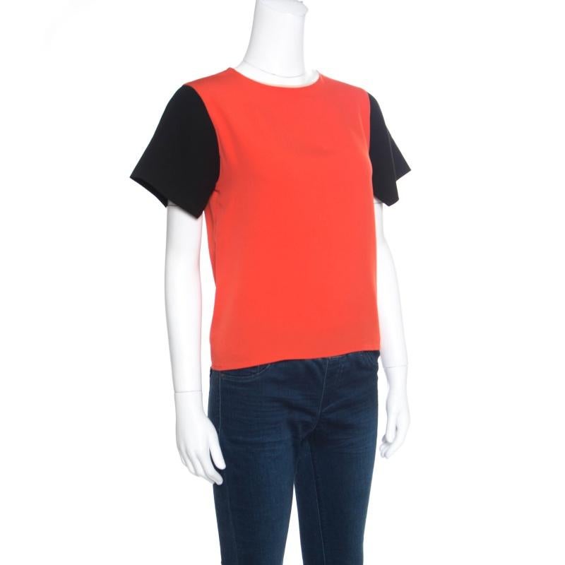 Minimal and sophisticated, this Celine top looks lovely! The orange creation is made of a silk blend and features a round neckline, contrasting short sleeves and a concealed zip closure at the back. Pair it with denims and loafers for a casual day
