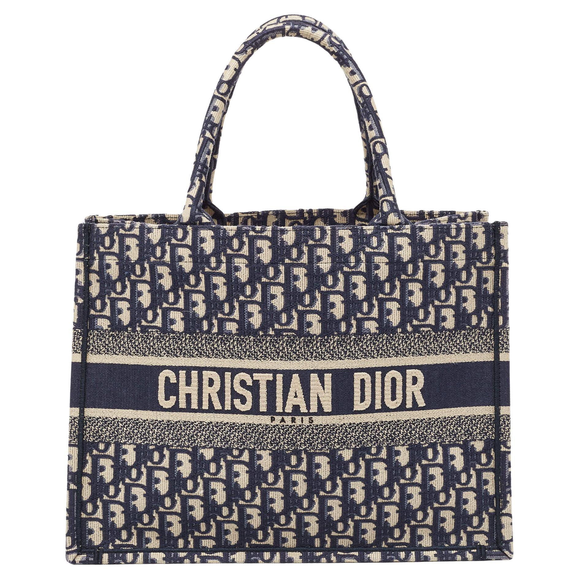 Designed by Maria Grazia Chiuri, the Dior Book Tote is a travel accessory for people with style. The bag here is crafted using canvas into a beautiful structure and covered in Oblique embroidery. Two handles, the 'Christian Dior' signature, and a
