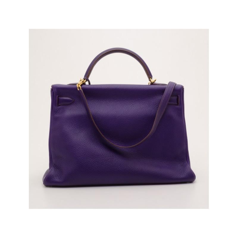 The famous Kelly by Hermes is a handbag that will remain a must-have bag for years to come. This version is crafted from supple Togo leather in purple iris. The c lassic exterior is detailed with a gold twist lock closure, a leather clochette,