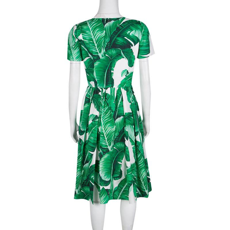 A part of the brand's Spring Summer 2016 collection, this Dolce & Gabbana dress features a banana leaf print inspired by the Botanical Garden of Palermo, Sicily. It has a feminine silhouette with a defined waistline and pleated bottom. Crafted with