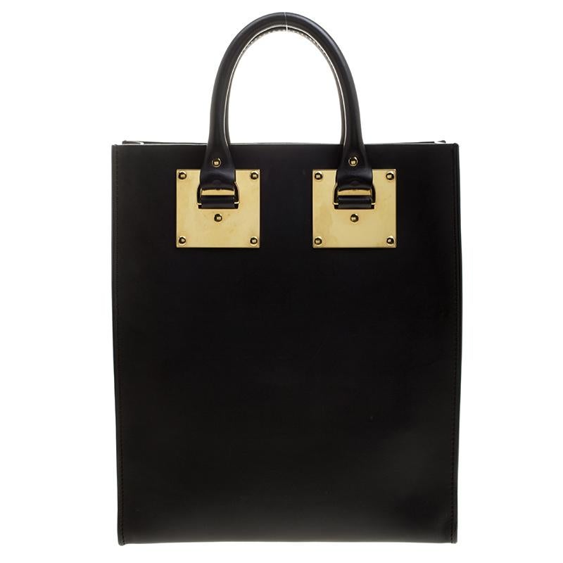 From the house of Sophie Hulme comes this sleek Albion tote that looks ready to assist your great style. Crafted wonderfully from black leather, this bag brings gold-tone hardware, two top handles and a spacious leather interior for all your
