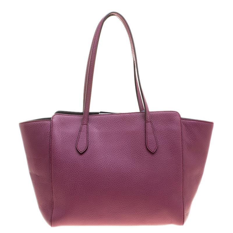 Gucci brings you this stylish and ornate tote in fun pink! With an expertly-lined canvas interior, this bag can accommodate all your accessories. An excellent, classy leather piece to own is surely this Swing tote.

Includes: The Luxury Closet