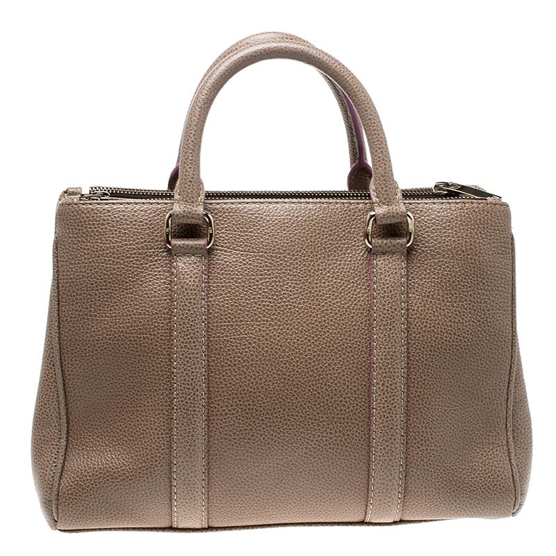 Be bold, be beautiful with this beige tote perfect for you. Watch your friends give you all the attention when you make an impressive appearance with this superb, posh leather piece. Designed with two handles and a canvas interior, it can handle all