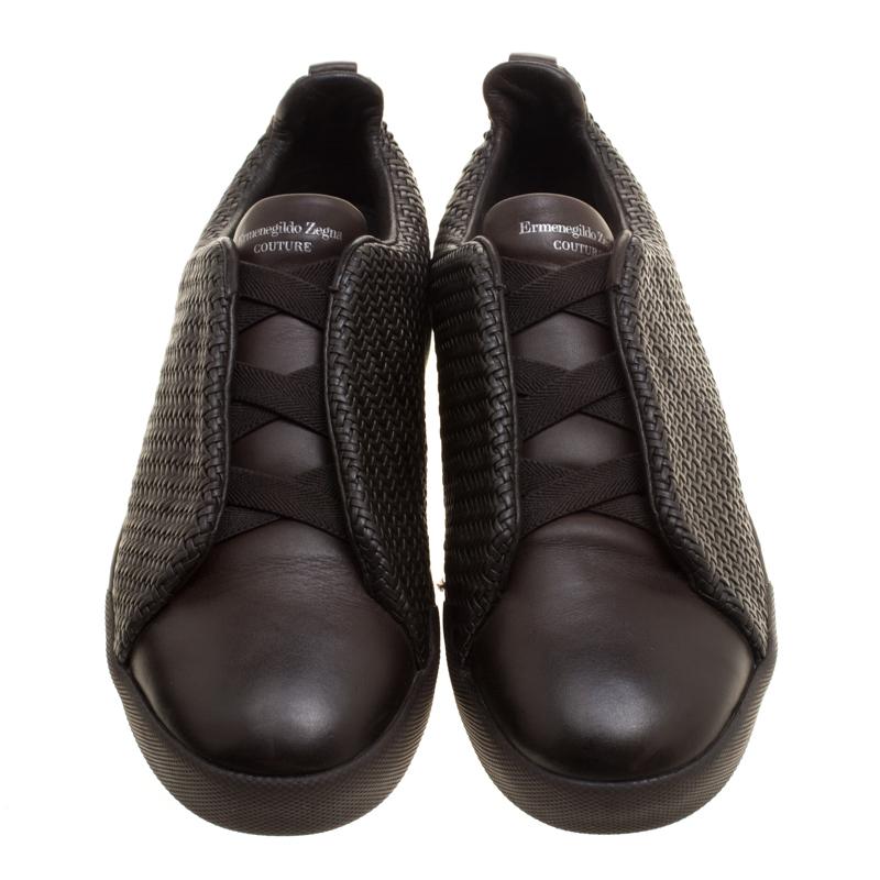 These easy slip-on sneakers from Ermenegildo Zegna Couture is a fine cross between formal and casual dressing. It is fabulously designed with Pelle Tessuta woven leather along with smooth leather vamps and criss-cross elastic straps. Complete with