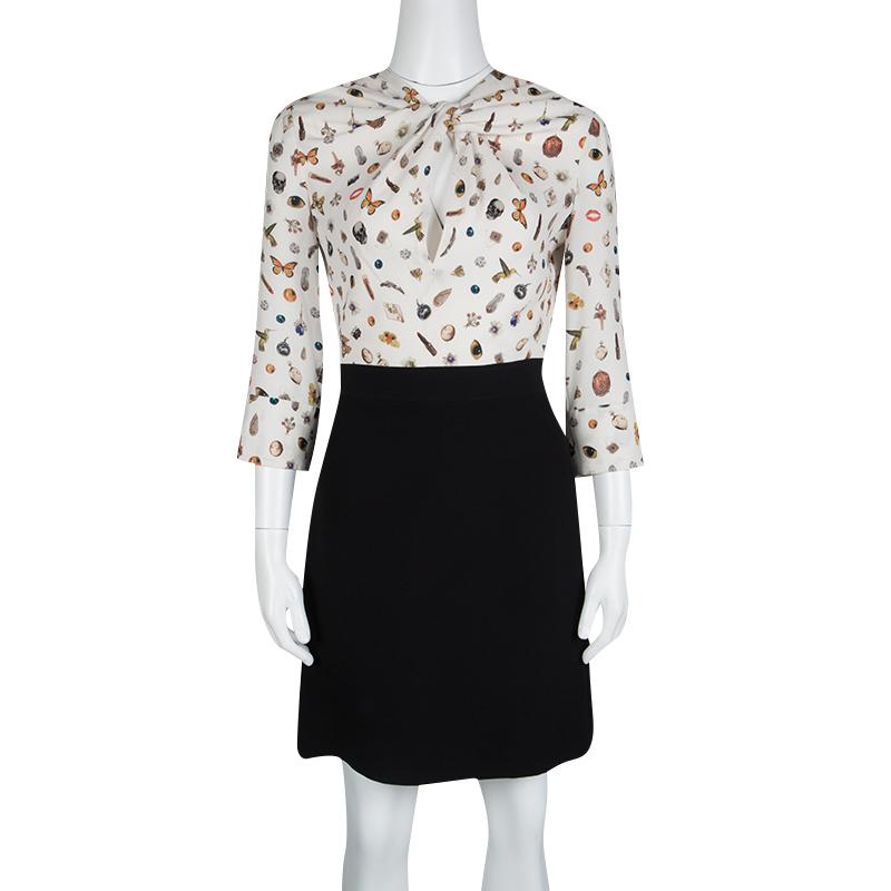 This cute dress from Alexander McQueen features the famous obsession print on the bodice, a print that is even loved by celebrities. This one was a part of their 2016's fall-winter collection. It has fitted silhouette with unique twist detail on the