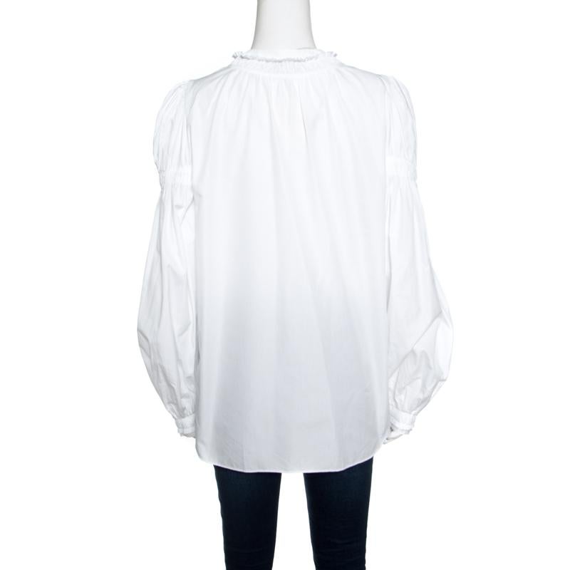 Alexander McQueen delights us with this lovely blouse that has been tailored from cotton-elastane blend and styled with long sleeves, ruffled gathered trims and button closures. This creation will look great with skinny jeans and high