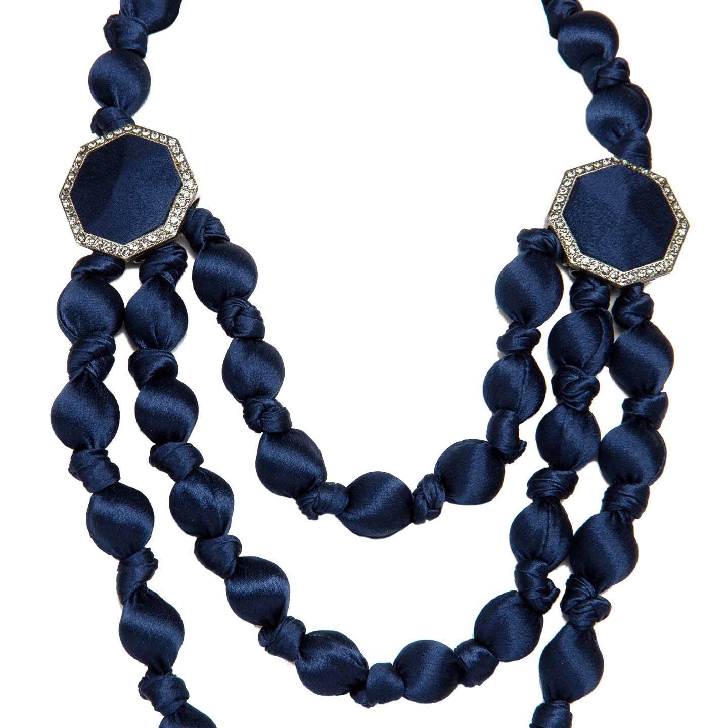 Royal blue silk covered glass stones 3 rows collier that ties with a grosgrain ribbon at back or side neck. Crystals embellished geometric charms and pendant enrich the elegant necklace. With all tags. Purchased at Browns London, UK. 

Size  29